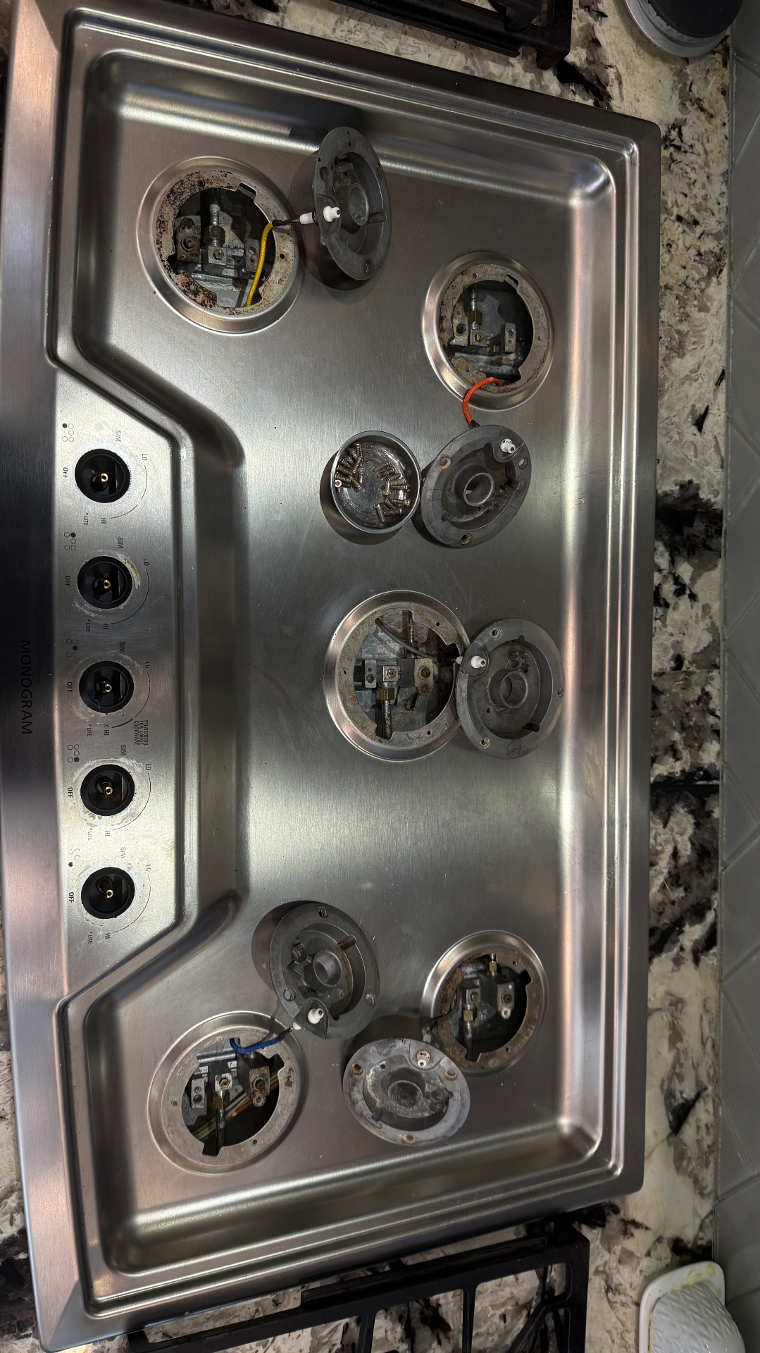 Burner assembly exposed on a kitchen cooktop