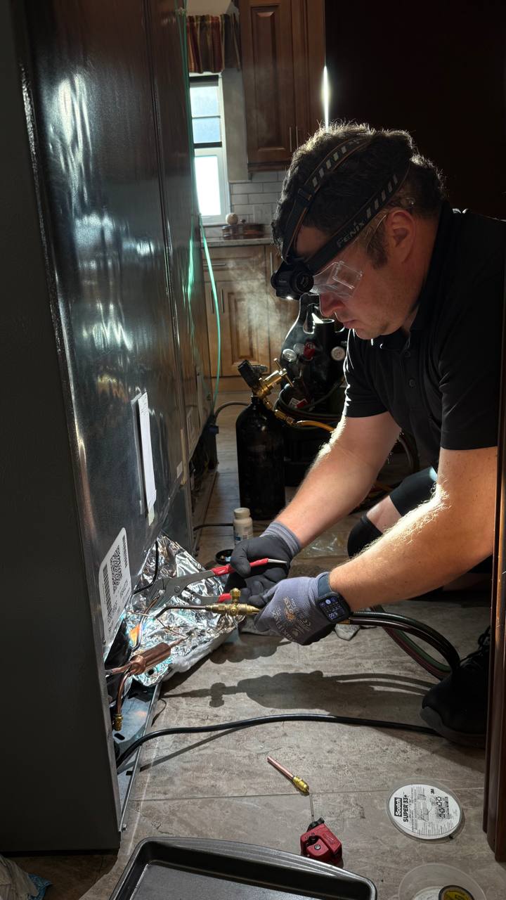 Cooling-system work inside a household refrigerator
